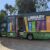 Green mobile library van with books painted on the side, parked outdoors with door open.